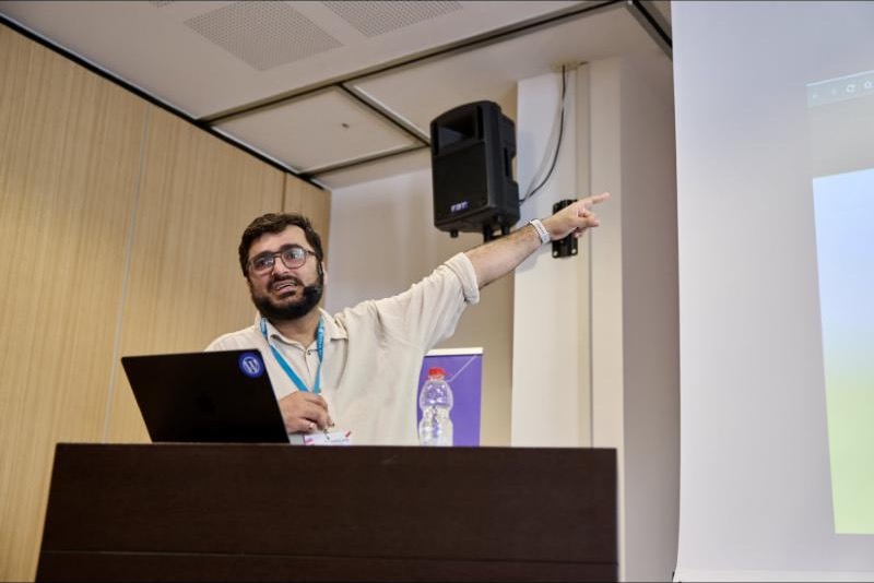 Vineet pointing at the screen during a talk