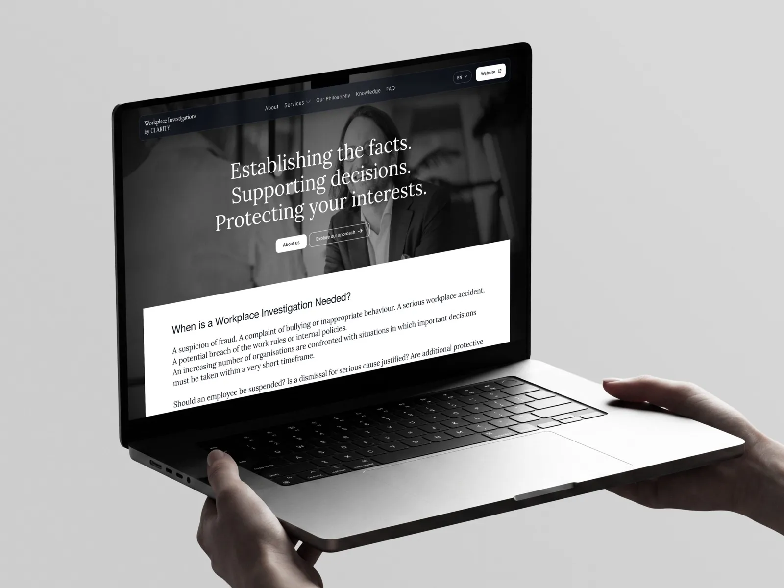 The Clarity Workplace Investigations website on a laptop